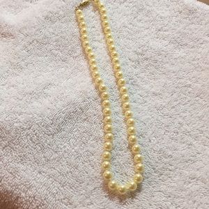 9 inches of string of faux pearls